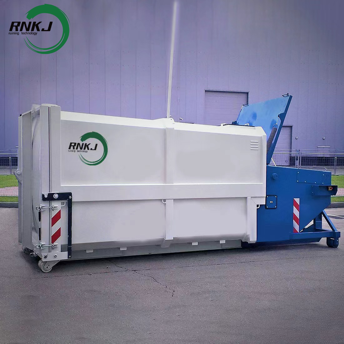 Commercial wet waste compactor installation at a food market loading dock